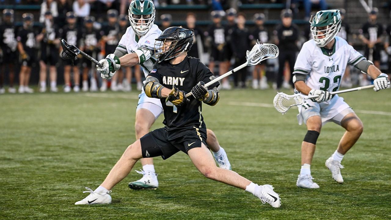 Army's Evan Plunkett unleashes a shot between Loyola defenders