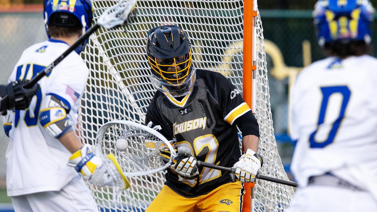 Towson goalie Luke Downs makes one of his 14 saves Friday in the Tigers' 11-10 win at Delaware.